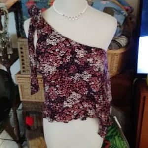 “Its pink" flowered top that is off 1 shoulder